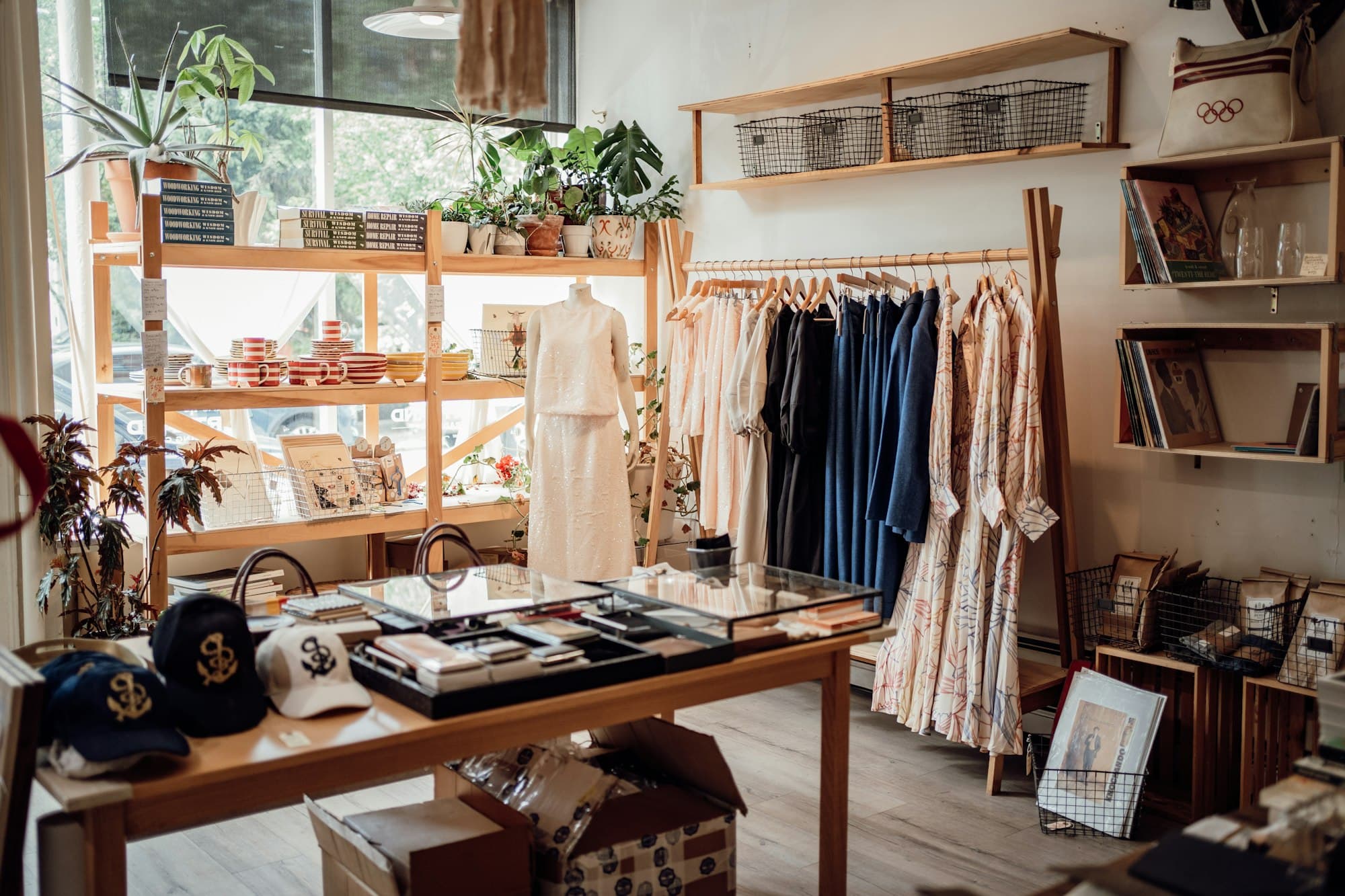 A small clothing boutique with clothes and hats on display